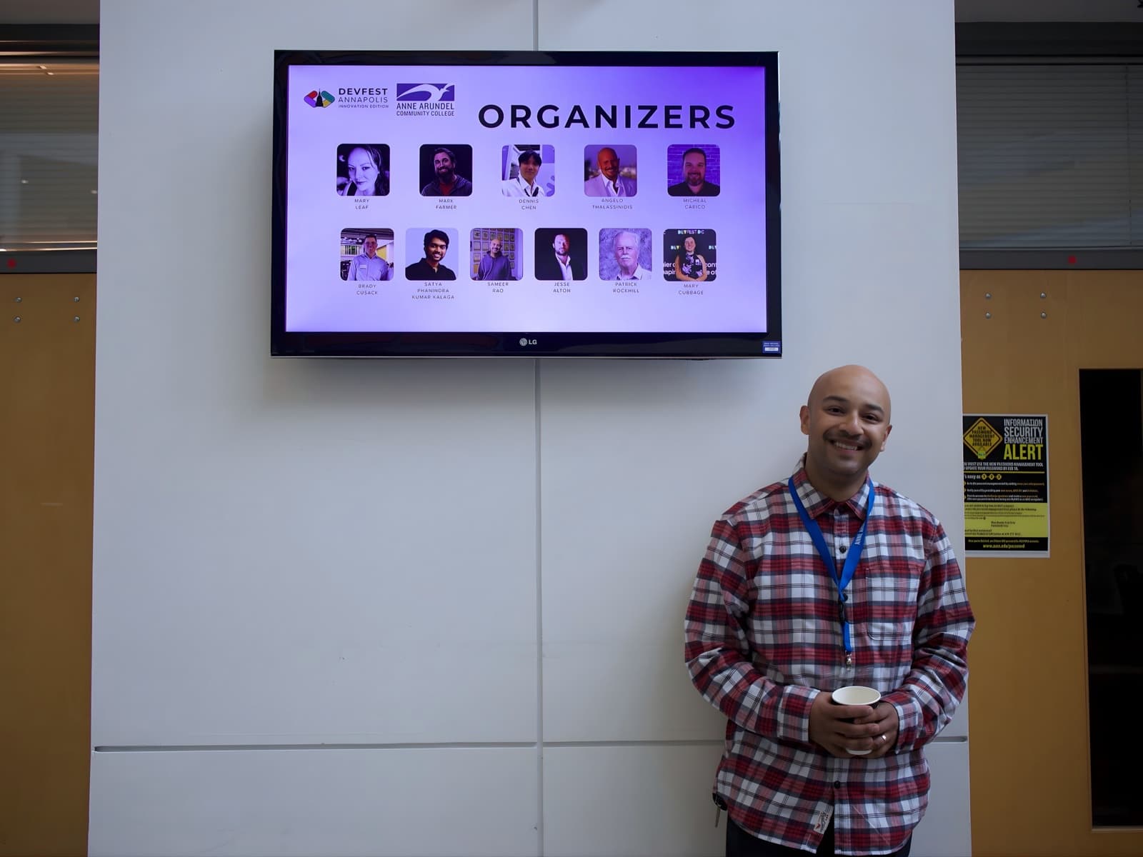 Organizer Sameer Rao under the even display showing the organizers