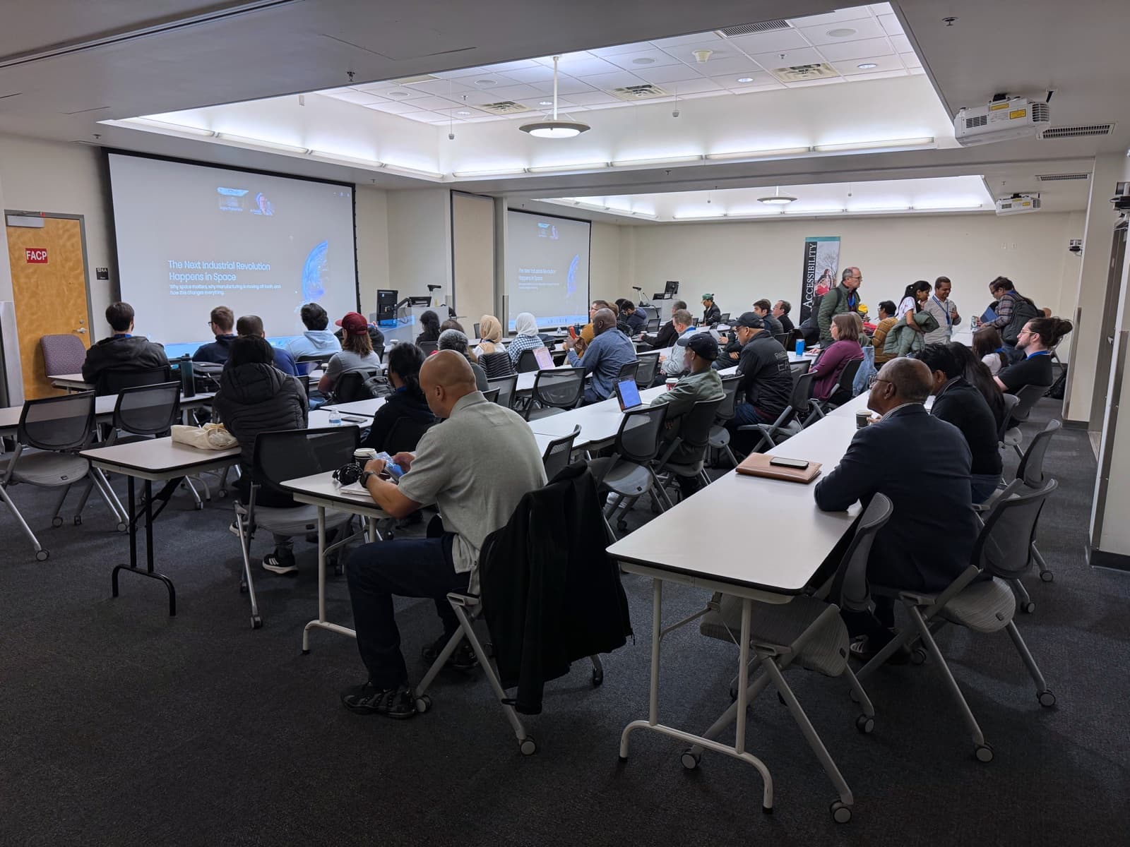 DevFest attendees watching a remote speaker